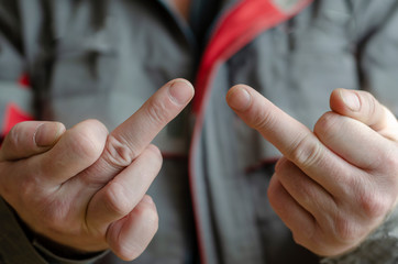 A man shows the camera gestures middle finger up.