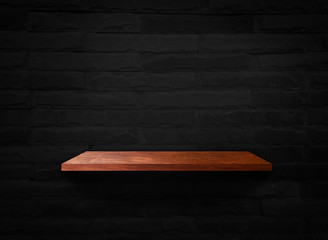 Wooden shelves on black brick wall texture background with clipping path for design
