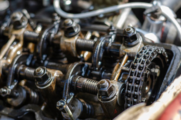 A detailed shot of the cylinder head of a carburetor engine.