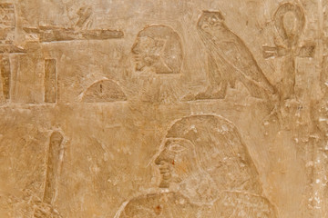 Ancient egyptian hieroglyphs carved on the stone wall