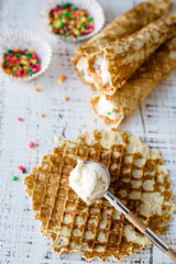 Homemade crispy waffles with ice cream and colorful sprinkles. 