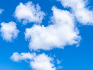 Obraz premium natural background - fluffy white clouds in blue sky on March day