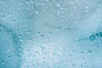 Raindrops on a car window. Rainy weather, sudden rain on the road.