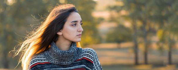 Autumn portrait of a girl in ethnic sweater