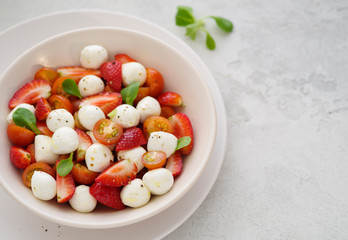 Salad with mozzarella, strawberries and cherry tomatoes. Healthy eating Vegetarian salad