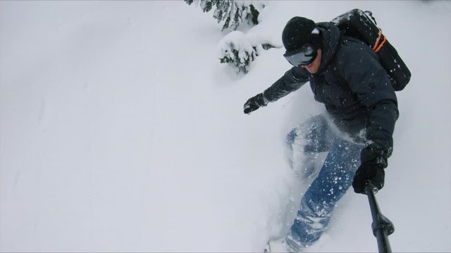 Snowboarding Deep Powder in Heavy Winter Snowfall Holding Selfie Stick