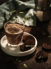 Glass of cocoa with chocolate ice cream and chocolate chip cookies with white cream. Early morning. Breakfast