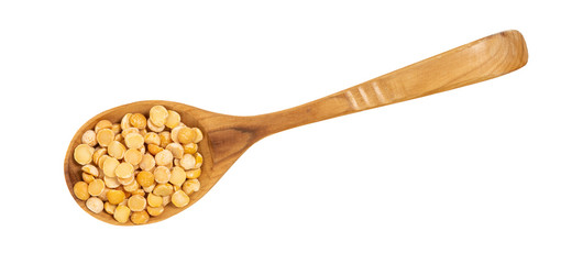 peas on a wooden spoon on a white background