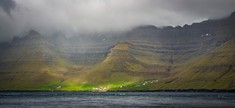 Small village of Kunoy in Faroe Islands fjord