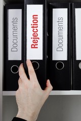 Rejection– finance/economics. File Folder is taken from office shelf. Male hand. Business,...
