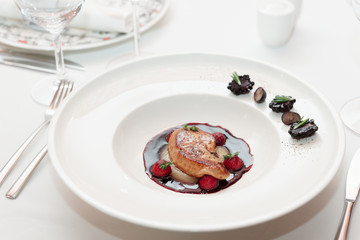 Foie gras with port sauce on white plate