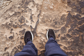 legs of man stepping on characteristic stone of Al-Habala canyon