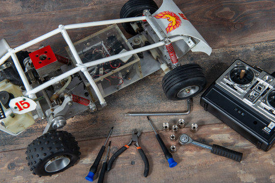Radio-controlled car model with tools for repairing rc buggy models and control panel.