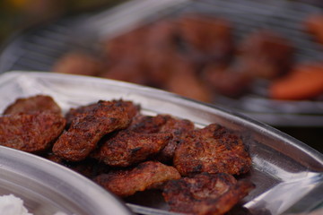 meatballs are cooking on the barbecue. cooking barbecue meat. man making barbecue meatballs. Enjoying a barbecue in the garden.