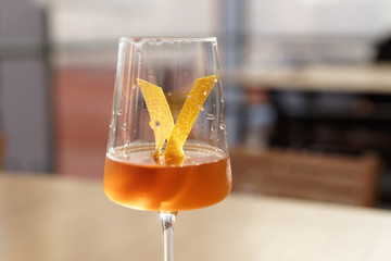 Yellow cocktail with lemon zest