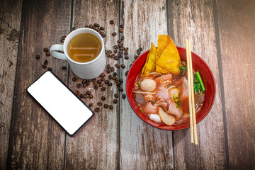 asian noodle soup with beef meatball with fresh vegetable on wood table vintage style, Noodle with hot tea, street food, hot and spicy noodle soup, asian food. Top view