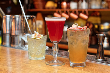 Three cocktails on bar counter