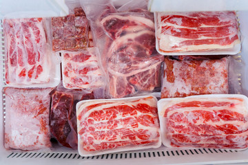 Fresh various meat wrapped on a box in freezer