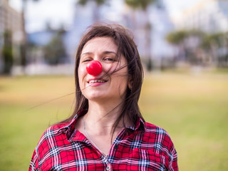 happy young girl with a clown nose. Joke, humor and funny portrait concept. April fools day