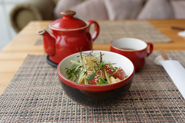 Poke bowl with ahi tuna and tea kettle