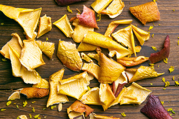 Beautiful dried apples on dark wooden background background. Top views