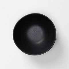 Empty blank black ceramic round bowl isolated on white background with shadow, Flat lay of traditional handcrafted kitchenware concept