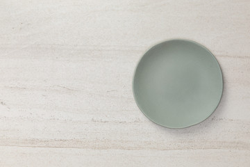 Blank green ceramic round dish on white stone blackground with copy space, Flat lay of traditional...