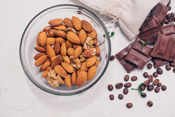 Chocolate, almonds, coffee beans on the table, top view