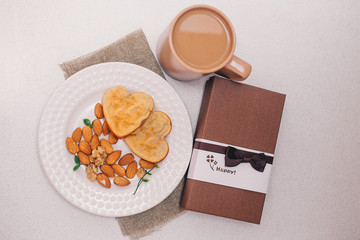 cupcake on a plate, almonds, coffee mug for Breakfast