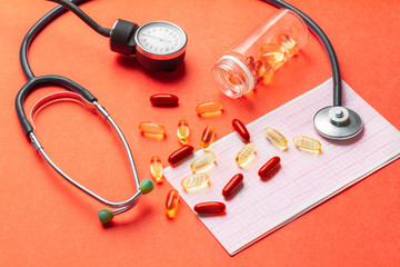 Pills, vitamins, stethoscope, cardiogram, on the table