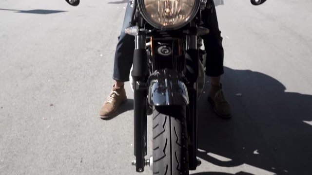 Straight on shot of a motorcycle.
Camera rises.
Man on bike.
Clip starts on the ground and moves up, then stopping at the mans chin.
Greensboro, North Carolina