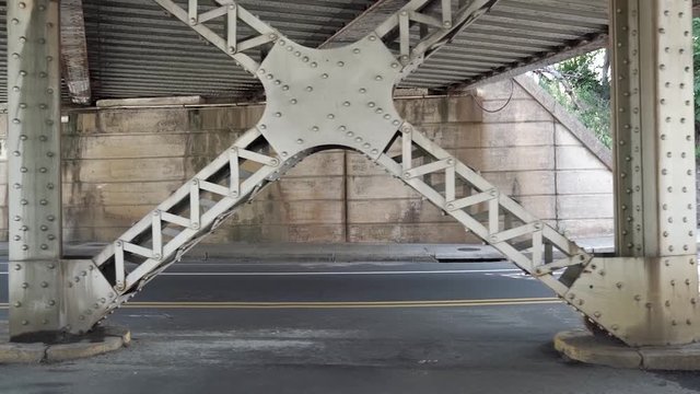 Motorcycle driver passing by under a bridge.
Camera pans left with driver.
Man on bike.
Greensboro, North Carolina