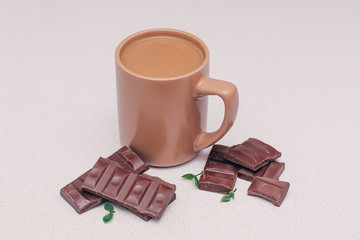 Coffee mug with milk and chocolate on the table for Breakfast