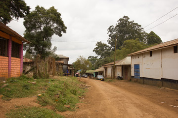 Fototapeta na wymiar Main street of an african village on a cloudy day