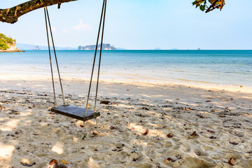 Covid-19 lockdown. Empty wooden swing hangs from tree on deserted beach on Ko Yao Noi island in Phang-Nga Bay near Phuket, Thailand
