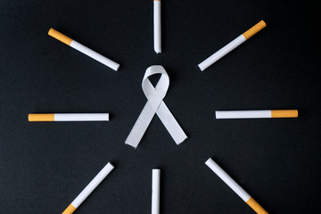 Top view of white ribbon and cigarette