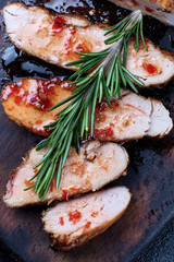 Grilled chicken fillets on wooden cutting board