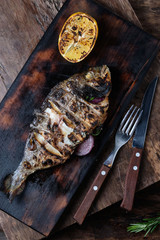 Grilled dorado served on cutting board