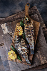 Grilled trout and dorado served on a cutting board