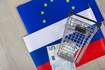 Shopping cart on European and Russian flags