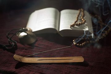 Out of focus open book with fragrance stick