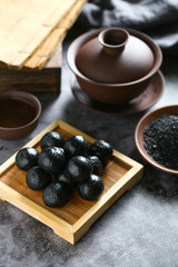 Chinese black sesame ball on bamboo plate with tea