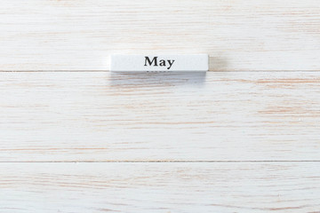 Wooden block of calendar with month May on wood background