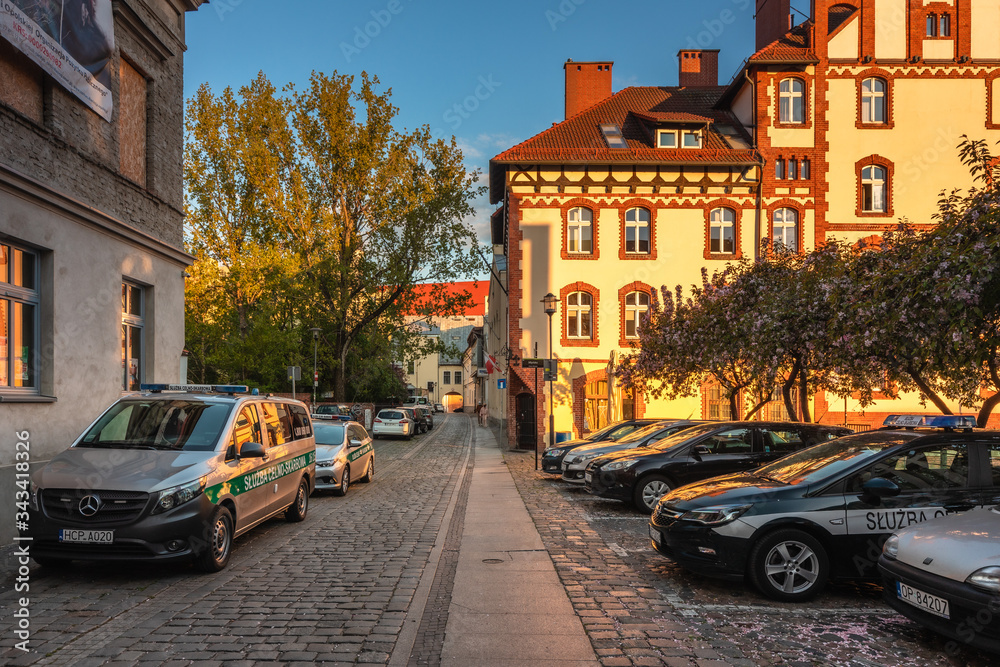 Wall mural Spring view of city Opole in Silesia in Poland. Historical old town in gold light.