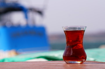 glass of Turkish tea on blue background
