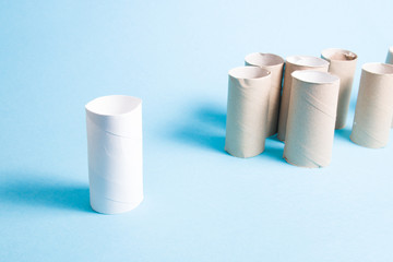 bushes from toilet paper stand in a heap separately from one sleeve which is different in white social distance concept, blue background, copy spaceÐ¼