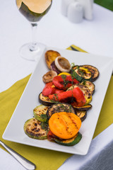 Plate of a sliced grilled vegetables. zucchini, onion, paprika, tomatoes
