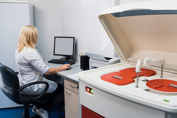 Doctor checking blood for viruses on a medical machine