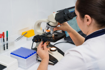 doctor looking into microscope, medicine concept. Checking blood test for viruses