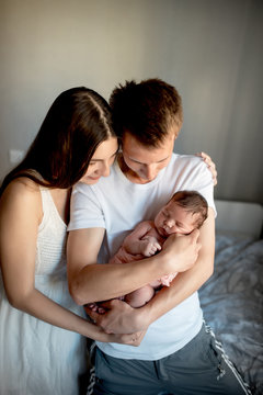 Newborn Baby With Mom And Dad At Home
